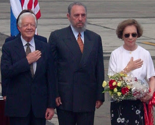 Former President Jimmy Carter and former First Lady Rosalynn Carter at an arrival ceremony for their 2011 trip to Cuba, flanking Cuban leader Fidel Castro.