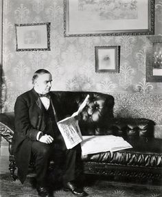 McKinley seated on his famous congressional black leather chaise sofa.