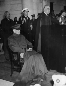 A feeble Pershing sits while the disabled President stands, delivering his Armistice Day speech at the ceremony.