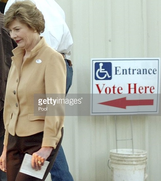 Laura Bush, ballot in hand, waits on line to vote in 2004 for her husband's successful re-election.
