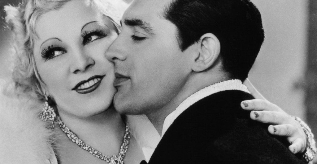Cary Grant, her favorite co-star, canoodles up for a kiss from an ambivalently amused Mae West in their 1934 film I'm No Angel.
