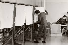 President Richard Nixon enters a San Clemente voting booth, many of which now included curtains to protect the privacy of the voter, 1972.