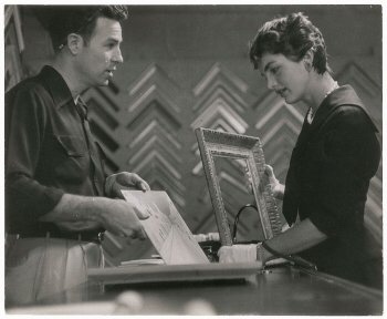 Mrs. Kennedy talks with a craftsman about a picture frame she wants made.