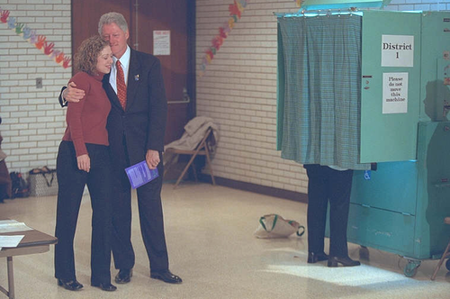 While Hillary Clinton votes behind a curtain in the 2000 election, her husband and daughter hug and smile, keeping faith the woman in the booth would be elected US Senator by night's end.